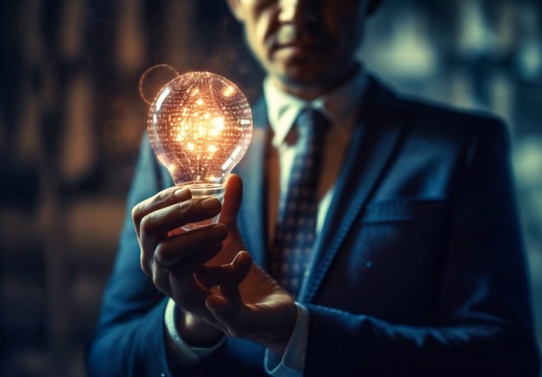 a business man holding a light bulb in front of a screen